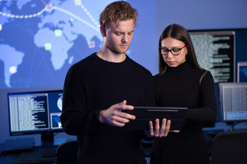 Focused professional cyber security team working to prevent security threats, find vulnerability...