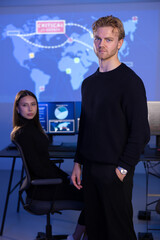 Male Cybersecurity Analyst and his team in Cyber Security Operation Center SOC handling Threats.
