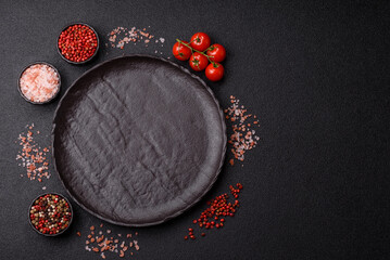 Empty round black plate for food, risotto or pasta. Empty plate on dark background