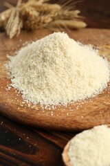 Pile of flour and spikes on wooden table, closeup
