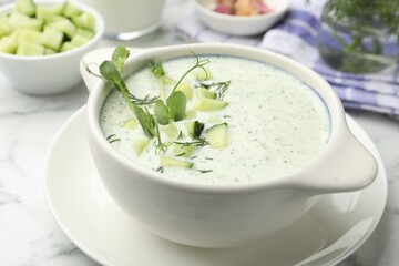 Tasty cucumber soup with dill, microgreens and ingredients on white marble table, closeup