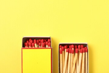 Matches and boxes on yellow background, flat lay. Mockup for design
