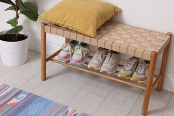 Different footwear on shelf in hallway indoors