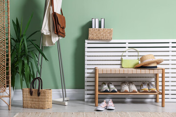 Different footwear, clothes and accessories in hallway