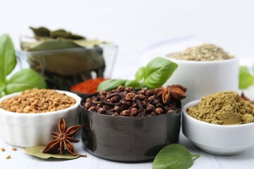 Different aromatic spices on white table, closeup