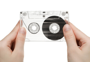 Woman with audio cassette on white background, closeup