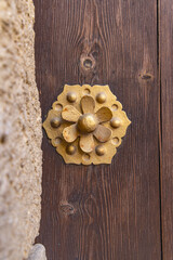 Arcos de la Frontera, Seville Province, Andalusia, Spain. Decorative brass work on an old Spanish door.
