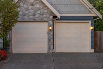 Garage door in luxury house with trees and nice landscape in Spring in Vancouver, Canada, North...