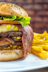 hamburger with french fries and bacon