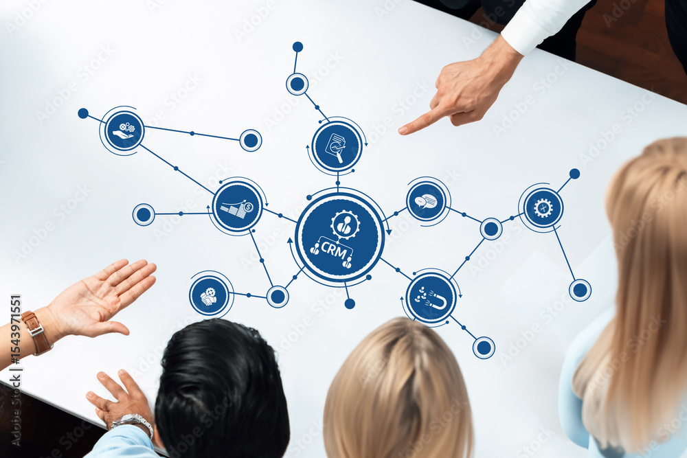 Aufkleber A diverse group of professionals analyzing a digital CRM strategy on a table, highlighting communication and collaboration in business growth and technology solutions. Amity