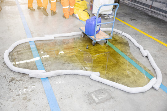 Industrial Spill Cleanup Using Absorbent Material on Contaminated Floor