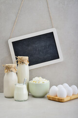 Various dairy products and eggs with framed chalk board