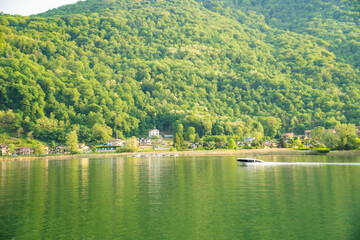 Spring view of Lake Lugano in the town of Caslano in the Swiss mountains