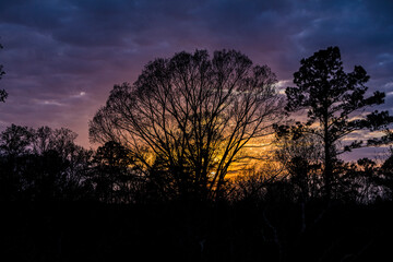 A Mississippi sun sets with blue and gold colors.