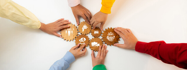 A group of diverse hands interact with gear-shaped icons, symbolizing collaboration and business...