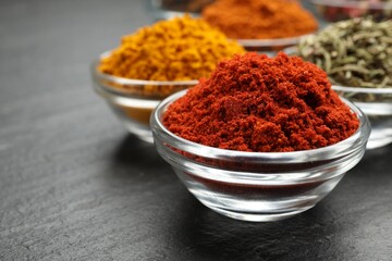 Different aromatic spices on grey table, closeup