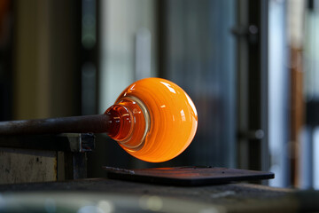 Artisans craft stunning glass orbs with traditional techniques in a sunlit workshop, highlighting the beauty of glassblowing. Craftsmanship concept. Generative AI.
