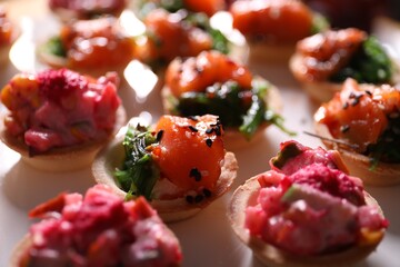 Buffet menu. Tasty stuffed tartlets on table, closeup
