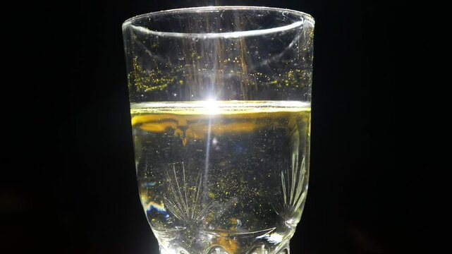 a glass filled with water plus turmeric powder produces a yellow light