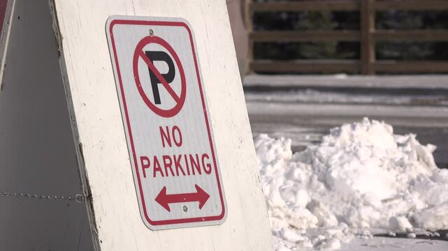 No parking sign with cars driving by in background 4k