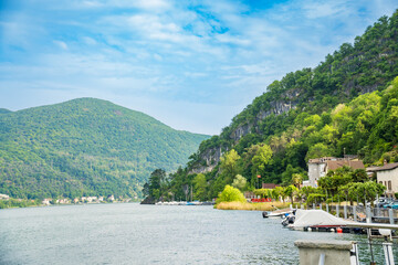 Spring view of Lake Lugano in the town of Caslano in the Swiss mountains