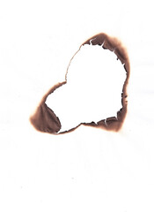 Love shape hole in fire burnet paper, Irregular Burnt Hole in White Paper with Smoky Charred Edges, Abstract Grunge Design Element
