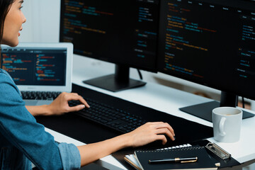 Young Asian in IT developer creating with typing online information on pc with coding program data...