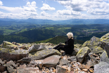 A woman looks at the landscape below.