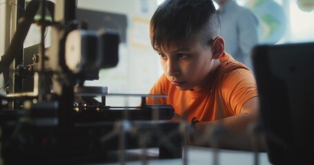 Talented Young Boy Sitting at Table, Studying Printing on Advanced Automated 3D Printer. Primary School Student Learning Programming, Innovative Technologies in Classroom. Interactive STEM Education.