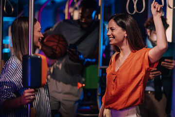 Young women talking and having fun on a moving bus at night