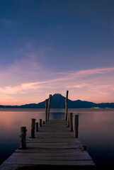 Starry night over Lake Atitl&aacute;n, Guatemala. Long exposure captures stars, volcanoes and colorful village lights reflecting on calm water, evoking peace, wonder, and adventure under the vast sky.