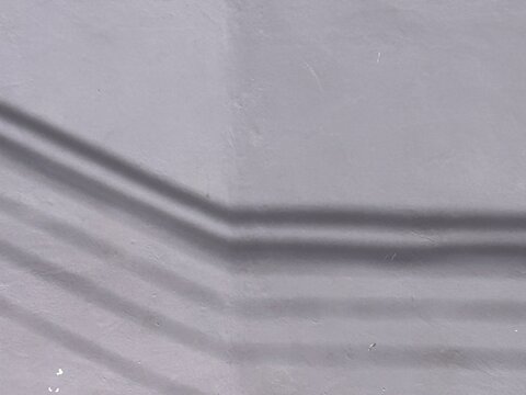 abstract background of a wall with a drawing of the shadow of electric wires