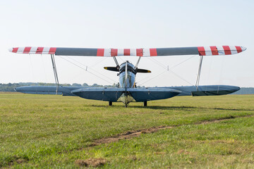 Soviet-made World War II green biplane on a grassy airfield