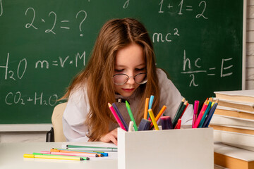 School kid in classroom. Girl with books. Student girl. Education concept. Schoolgirl in school. Schoolgirl in high school. College student learning in college. Lesson and homework. School Background.