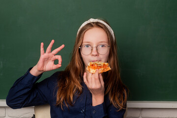 Schoolgirl. Schoolkid or preschooler. Back to school. School girl. School child. Portrait of elementary pupil. School kid eating pizza. Little girl and eating tasty pizza.