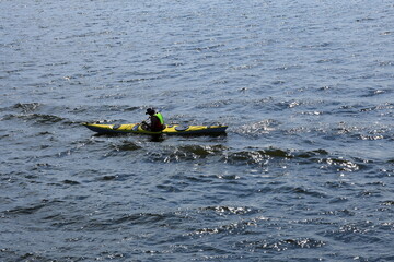 Man in a yellow canoe. Lake Mälaren, Sweden.