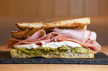 focaccia sandwich with mortadella, burrata and pesto