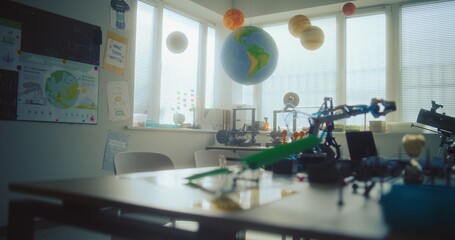 Modern Science Classroom with Hanging Solar System Models, 3D Printers, Robotic Arms and Renewable Energy Model Builder. STEM Learning Focused on Innovation, Exploration, Hands-on Technology Projects. © Framestock
