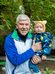 A man is holding a baby in his arms