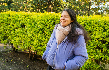 A woman wearing a blue jacket and a scarf