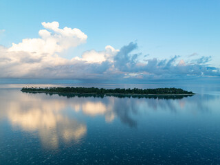 Evening light illuminates an island within Wakatobi National Park, off the coast of Sulawesi. This area is a popular destination for divers and snorkelers due to its high marine biodiversity.