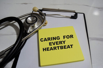 Concept of Caring for every heartbeat write on sticky notes isolated on Wooden Table.