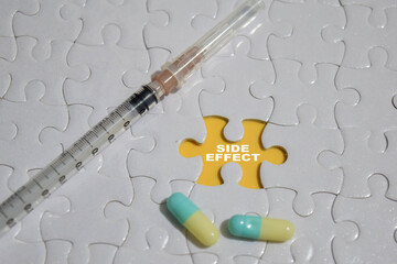 Hand holding piece of jigsaw puzzle with word Side effect.
