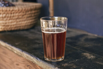 a clear glass of tella  traditional ethiopian beer