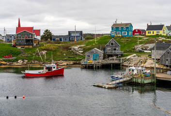 Fishing boat sails into the harbour of Peggys Cove near Halifax in Nova Scotia, Canada