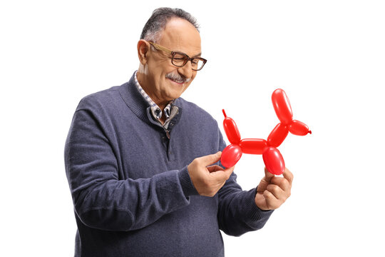 Mature man looking at a red balloon twisted in a dog shape - Powered by Adobe