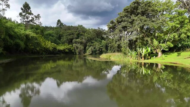 Drone shot over calm waters of Lower Saosa Dam near Mau Forest, Kericho, surrounded by greenery