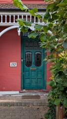 Old victorian wooden door with stained glass in a red brick wall, London