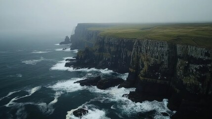 Dramatic Cliffs and Ocean Waves in Misty Weather