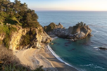 McWay Falls tumbles onto the beach at Julia Pfeiffer Burns State Park. The waterfall flows...